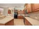 Spacious kitchen featuring stainless steel appliances and dark wooden cabinets with ample storage at 4920 Woodhurst Dr, Sarasota, FL 34243