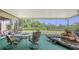 Covered lanai featuring an alligator statue and lake view for outdoor enjoyment at 4920 Woodhurst Dr, Sarasota, FL 34243
