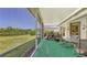 Relaxing screened lanai with lush landscaping, putting green, and peaceful lake view at 4920 Woodhurst Dr, Sarasota, FL 34243