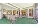 Spacious lanai with multiple seating areas and views of the property's landscape at 4920 Woodhurst Dr, Sarasota, FL 34243