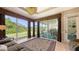 A spacious living room with large windows, scenic views, and a comfortable seating area at 4920 Woodhurst Dr, Sarasota, FL 34243