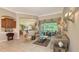 Comfortable living room featuring elegant seating, refined décor, and abundant natural light from the large windows at 4920 Woodhurst Dr, Sarasota, FL 34243