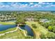Stunning aerial view of a golf course, lake, and lush green landscaping at 5035 Tobermory Way, Bradenton, FL 34211