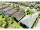 An aerial view showcasing a home with a tile roof in a neighborhood with manicured lawns at 5035 Tobermory Way, Bradenton, FL 34211