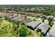 Aerial view of the neighborhood showcasing the surrounding trees, pond and beautiful homes at 5035 Tobermory Way, Bradenton, FL 34211