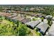 Aerial view of the property with lush landscaping and community pond in the distance at 5035 Tobermory Way, Bradenton, FL 34211