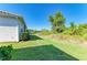 Side yard showing the well-maintained lawn, plants and shrubbery at 5035 Tobermory Way, Bradenton, FL 34211