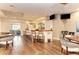 Stylish bar area with ample seating, warm lighting, and multiple TV screens for entertainment at 5035 Tobermory Way, Bradenton, FL 34211
