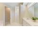 Bright bathroom showcasing double sinks, walk-in shower, and marble countertops and flooring at 5035 Tobermory Way, Bradenton, FL 34211
