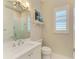 Bright bathroom with a glass shower, white vanity, and elegant plantation shutters at 5035 Tobermory Way, Bradenton, FL 34211