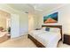 Serene bedroom featuring a ceiling fan, a large window with shutters, and neutral decor at 5035 Tobermory Way, Bradenton, FL 34211