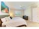 Comfortable bedroom features a ceiling fan, a large window with shutters, and neutral decor at 5035 Tobermory Way, Bradenton, FL 34211