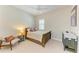 Cozy bedroom with neutral color palette, ceiling fan, plantation shutters, and charming decor at 5035 Tobermory Way, Bradenton, FL 34211