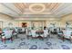 Elegant dining area with circular tables and seating, featuring a modern chandelier at 5035 Tobermory Way, Bradenton, FL 34211