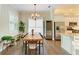 Dining area features a rustic wooden table, a modern wine fridge, and abundant natural light at 5035 Tobermory Way, Bradenton, FL 34211