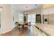 Bright dining area with wood table, modern wine fridge, and window shutters at 5035 Tobermory Way, Bradenton, FL 34211
