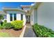Charming entrance with lush landscaping and a stone walkway leading to the front door at 5035 Tobermory Way, Bradenton, FL 34211