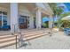 Elegant entrance with stone steps, lanterns, and potted plants, creating a welcoming and upscale atmosphere at 5035 Tobermory Way, Bradenton, FL 34211