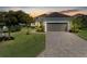 Beautiful single-story home with manicured lawn, brick driveway, and neutral paint scheme at 5035 Tobermory Way, Bradenton, FL 34211