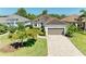 Charming home featuring a brick driveway, lush landscaping, and a welcoming facade at 5035 Tobermory Way, Bradenton, FL 34211