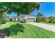 Beautiful single-story home with a well-manicured lawn, paver driveway and a neutral colored two-car garage at 5035 Tobermory Way, Bradenton, FL 34211