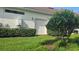 Well-maintained exterior with a white garage door and trimmed hedges at 5035 Tobermory Way, Bradenton, FL 34211
