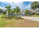 A sprawling patio with blue umbrellas and lush landscaping surrounding the building for a tranquil outdoor setting at 5035 Tobermory Way, Bradenton, FL 34211