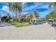 Expansive patio area with comfortable seating, blue umbrellas, and lush landscaping surrounding the building at 5035 Tobermory Way, Bradenton, FL 34211