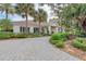 Beautiful building with a landscaped walkway, bench, and lush surroundings, creating a serene setting at 5035 Tobermory Way, Bradenton, FL 34211