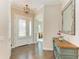 Welcoming foyer with wood floors, white doors with shutters, and a decorative console table with mirror at 5035 Tobermory Way, Bradenton, FL 34211