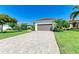 Charming home featuring a paved driveway, and lush landscaping in the front at 5035 Tobermory Way, Bradenton, FL 34211