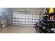 Spacious garage with organized storage shelves, a bike, and an insulated garage door at 5035 Tobermory Way, Bradenton, FL 34211