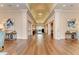Elegant hallway with wood floors, columns, and vaulted ceilings leading to a bright, open space at 5035 Tobermory Way, Bradenton, FL 34211