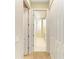 Bright hallway featuring neutral tones and white closet doors leading to the Primary bathroom at 5035 Tobermory Way, Bradenton, FL 34211
