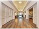 Well-lit hallway with wood floors and white trim, offering access to various rooms and amenities at 5035 Tobermory Way, Bradenton, FL 34211