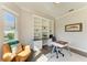 Bright home office with custom built-ins and large window that let in an abundance of natural light at 5035 Tobermory Way, Bradenton, FL 34211