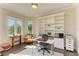 Bright home office with custom built-ins and large windows that let in an abundance of natural light at 5035 Tobermory Way, Bradenton, FL 34211