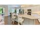 Modern kitchen featuring stainless steel appliances, white cabinets, and a large center island at 5035 Tobermory Way, Bradenton, FL 34211