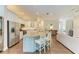 Modern kitchen with a large center island, white cabinetry, and stainless steel appliances at 5035 Tobermory Way, Bradenton, FL 34211