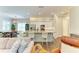 Open-concept living area flows into a kitchen with an island and a dining area with a large window at 5035 Tobermory Way, Bradenton, FL 34211
