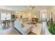 Open-concept living room with wood floors and neutral-toned decor at 5035 Tobermory Way, Bradenton, FL 34211