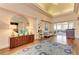 Spacious lounge area with elegant furnishings, wood floors, and decorative mirror at 5035 Tobermory Way, Bradenton, FL 34211