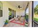 Enjoy an outdoor living space on this covered patio with comfortable seating and scenic views at 5035 Tobermory Way, Bradenton, FL 34211