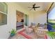 Comfortable screened patio featuring modern ceiling fan and view to the living area at 5035 Tobermory Way, Bradenton, FL 34211