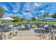 Beautiful patio with blue umbrellas and chairs under string lights, perfect for outdoor dining and entertaining at 5035 Tobermory Way, Bradenton, FL 34211