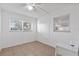 Spare bedroom with two windows, tile floors, and a ceiling fan at 505 47Th Avenue W Dr, Bradenton, FL 34207