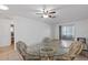 Open dining area with ceiling fan, tile floor, and glass table at 505 47Th Avenue W Dr, Bradenton, FL 34207