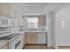 Bright kitchen featuring white appliances, tile floor, and ample counter space at 505 47Th Avenue W Dr, Bradenton, FL 34207