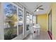 Enclosed lanai with tile flooring, ceiling fan, and furniture at 505 47Th Avenue W Dr, Bradenton, FL 34207