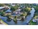 Exceptional aerial perspective showcasing a waterfront home with a pool, dock, and lush greenery along the canal at 5500 Merrimac Dr, Sarasota, FL 34231